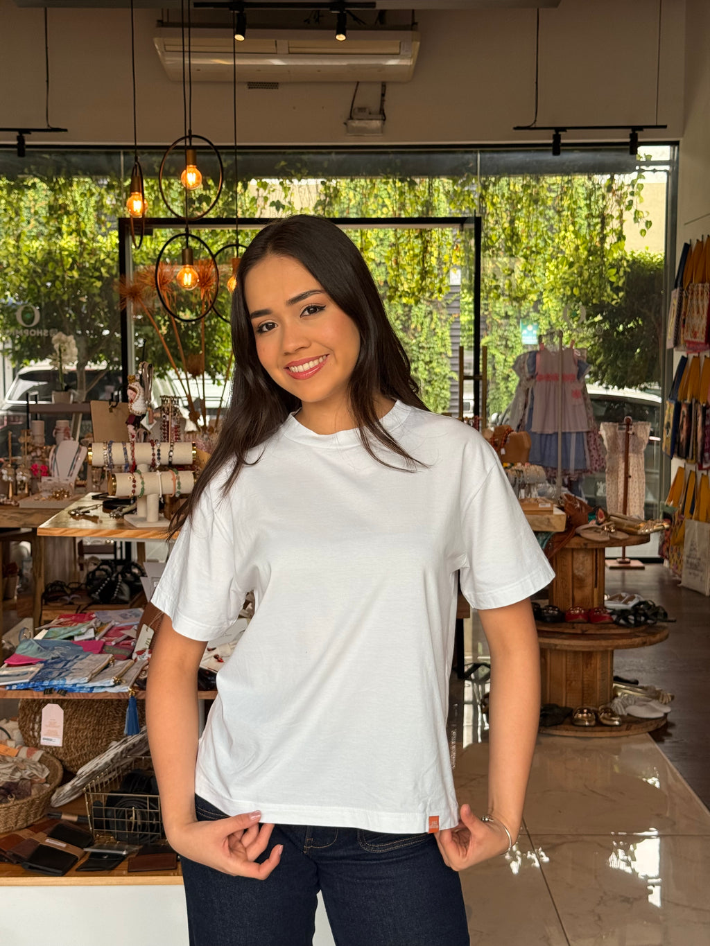 Woman wearing 503Cher@s Women's Oversized Top with jeans in store
