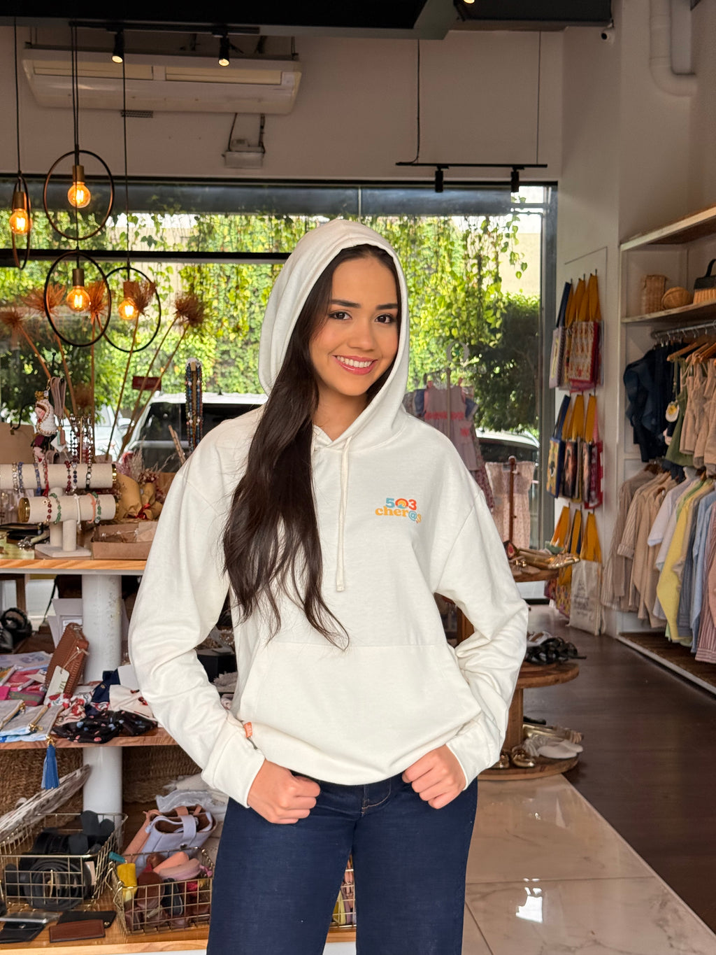 Woman wearing Hoodie Volcán Ilamatepec in store showing 503Cher@s logo on chest